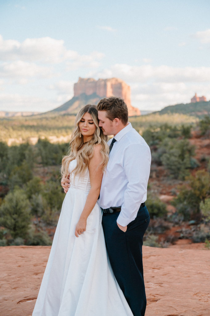 Bride and groom sharing a quiet moment among the Sedona red rocks.