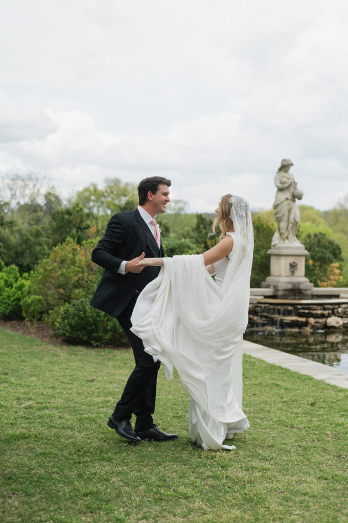 Romantic portrait of the bride and groom at the reflection pool in Cheekwood gardens.