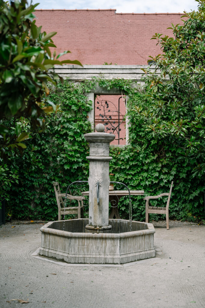 bride holding bouquet in fountain outdoors at the apiary, wedding venue in lexington kentucky, taken by Keely Nichole Photography