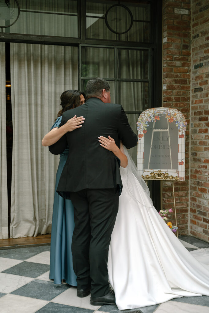 Father, sister and bride hug at The Apiary wedding in downtown Lexington.