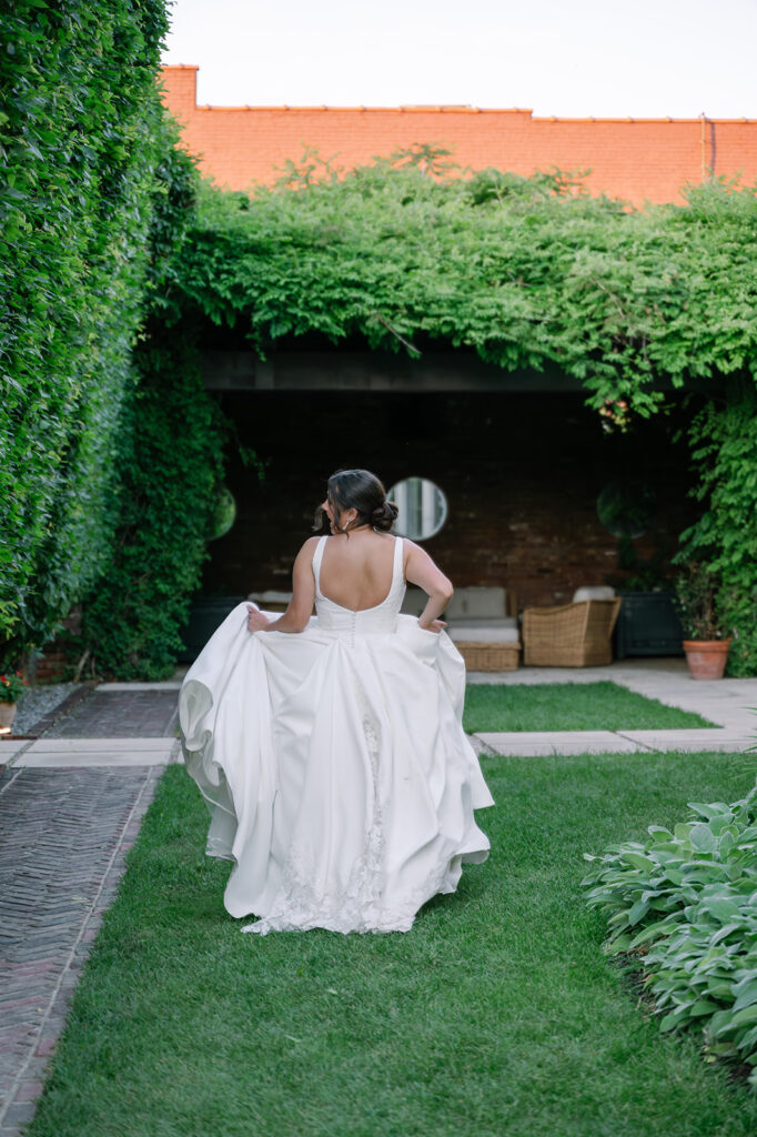 Romantic portrait outside The Apiary in Lexington with bride running through the gardens. 