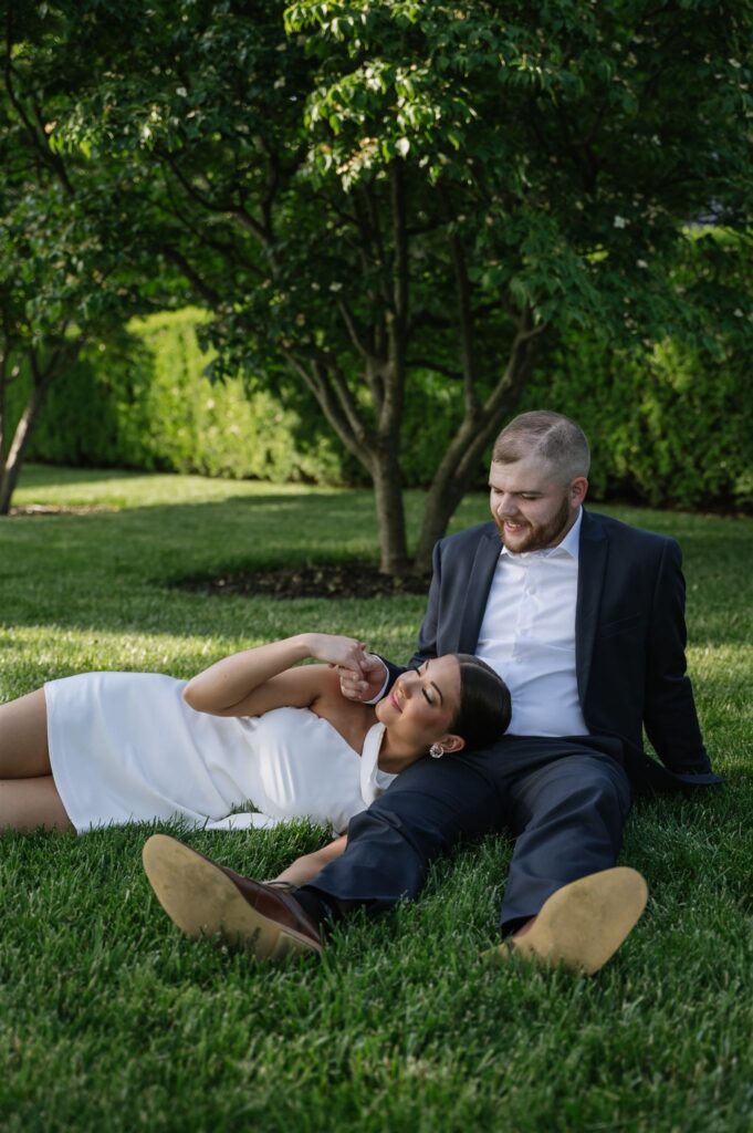 Couple resting on across open lawn near historic details at a Keeneland wedding venue
