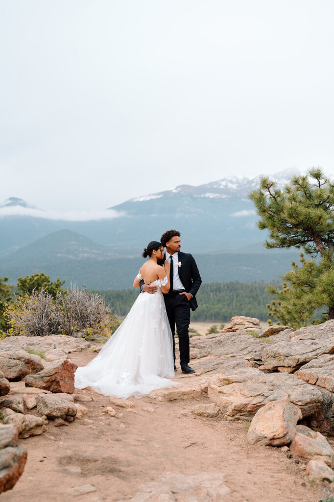 Bride and groom exploring alpine scenery in Rocky Mountain National Park.
