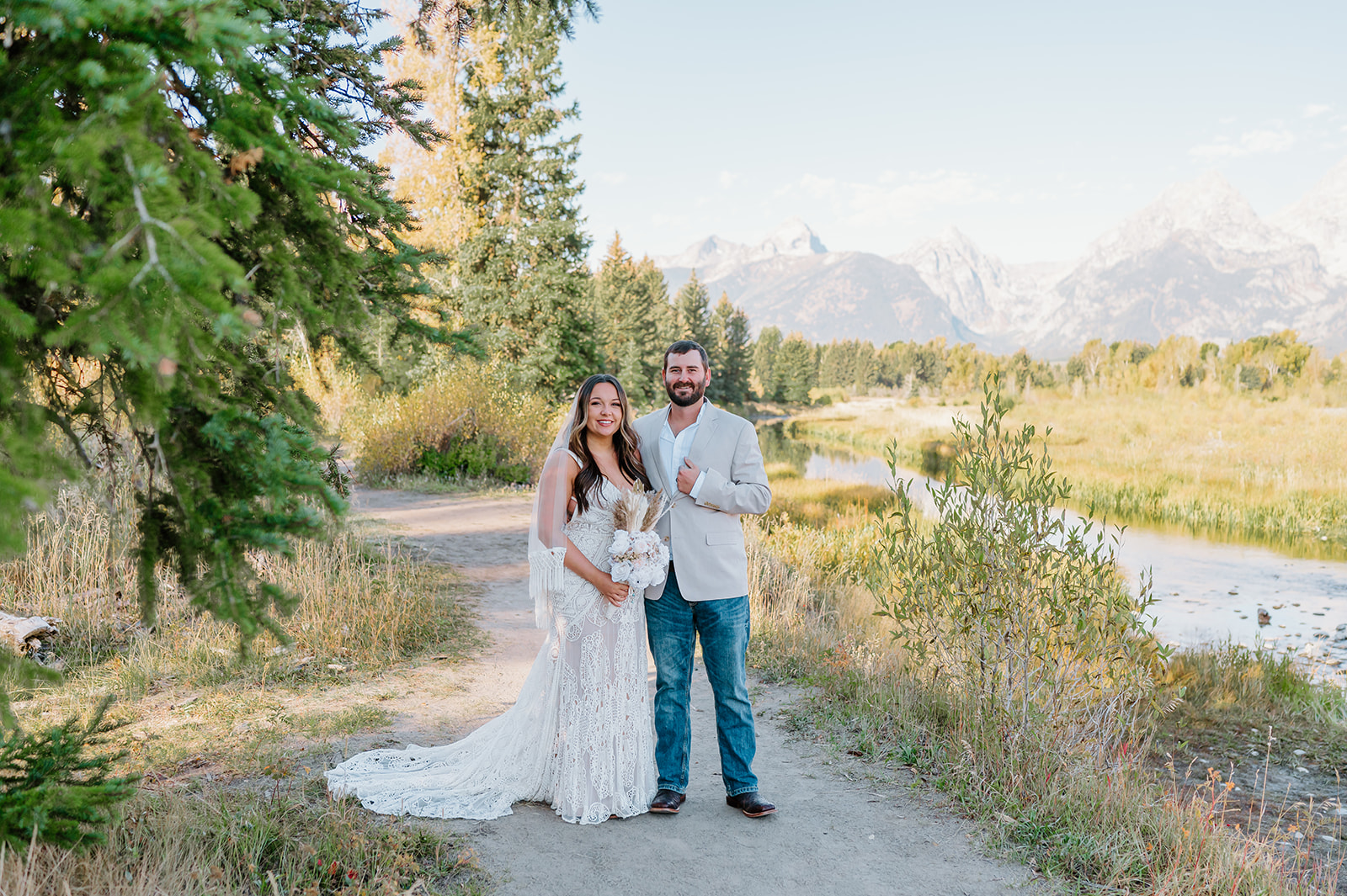 Couple embracing with sweeping mountain views in the Tetons.