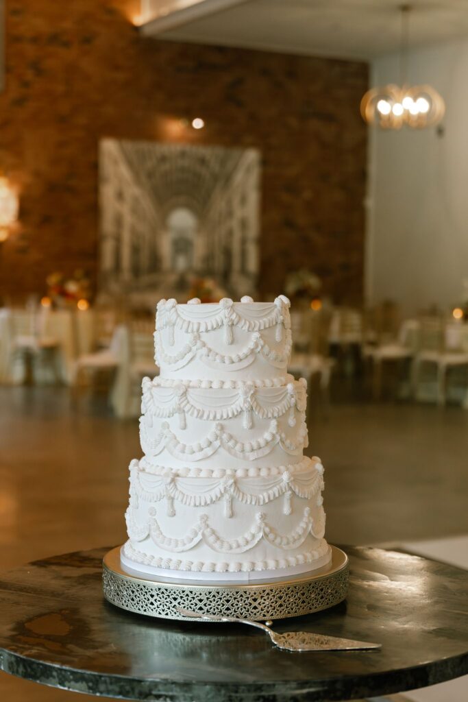 Vintage-inspired wedding cake displayed during the reception at Hazelnut Farm Events in Louisville, KY. 