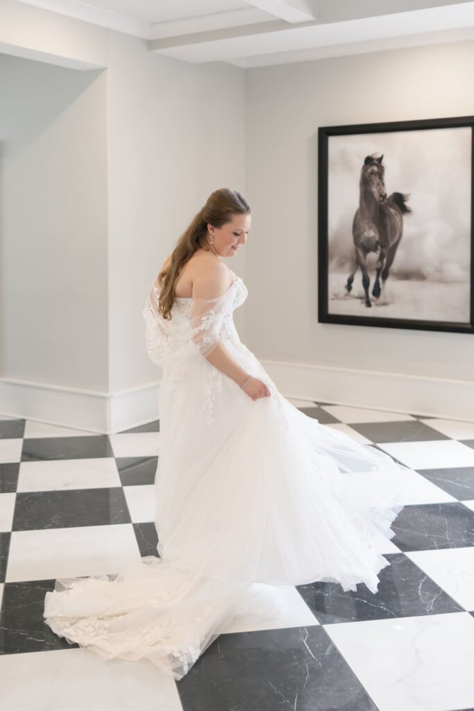 Bride twirling on the black-and-white dance floor featured in Hazelnut Farm Events photos. 