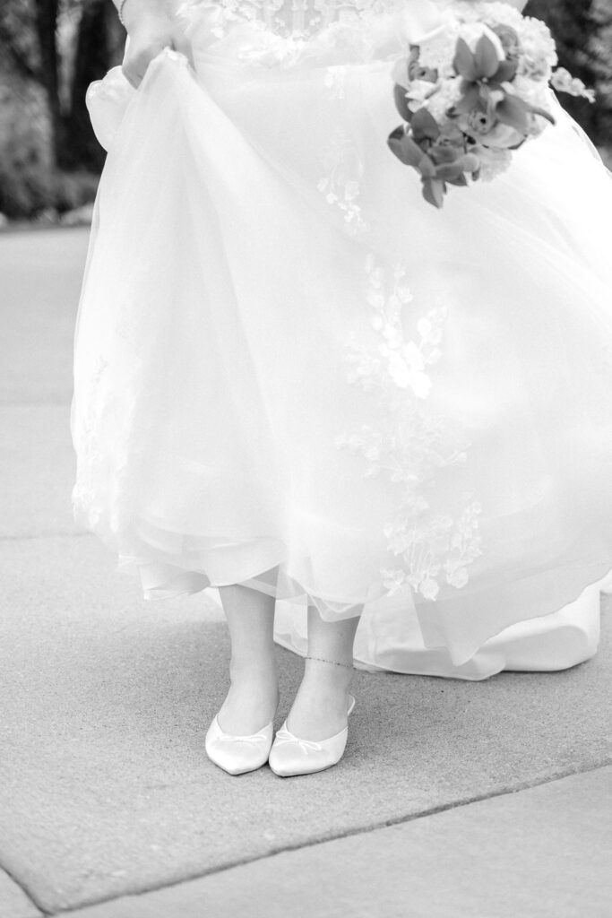 Bride holding her wedding gown and bouquet during portraits at Hazelnut Farm Louisville, KY. 