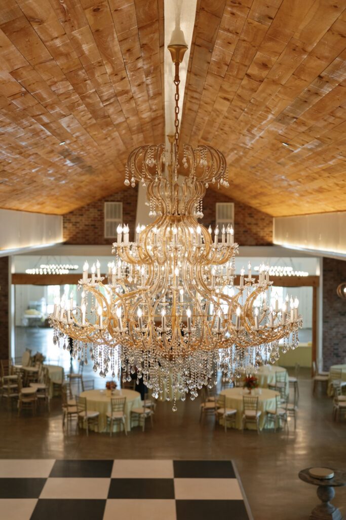 Elegant ballroom chandelier and black-and-white dance floor at Hazelnut Farm Louisville, KY wedding venue. 