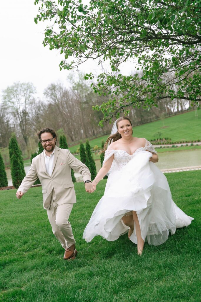 Bride and groom running across the lawn during a joyful Hazelnut Farms wedding portrait session. 