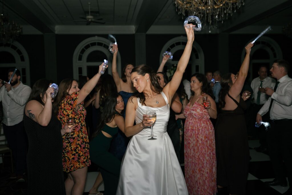 Wedding guests and bride celebrating on the dance floor during a lively reception at a historic wedding venue in Louisville, KY.