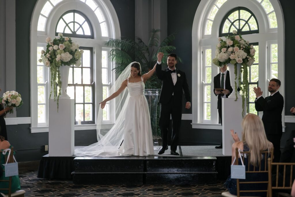 Bride and groom celebrating their ceremony exit inside one of the historic wedding venues Louisville KY.