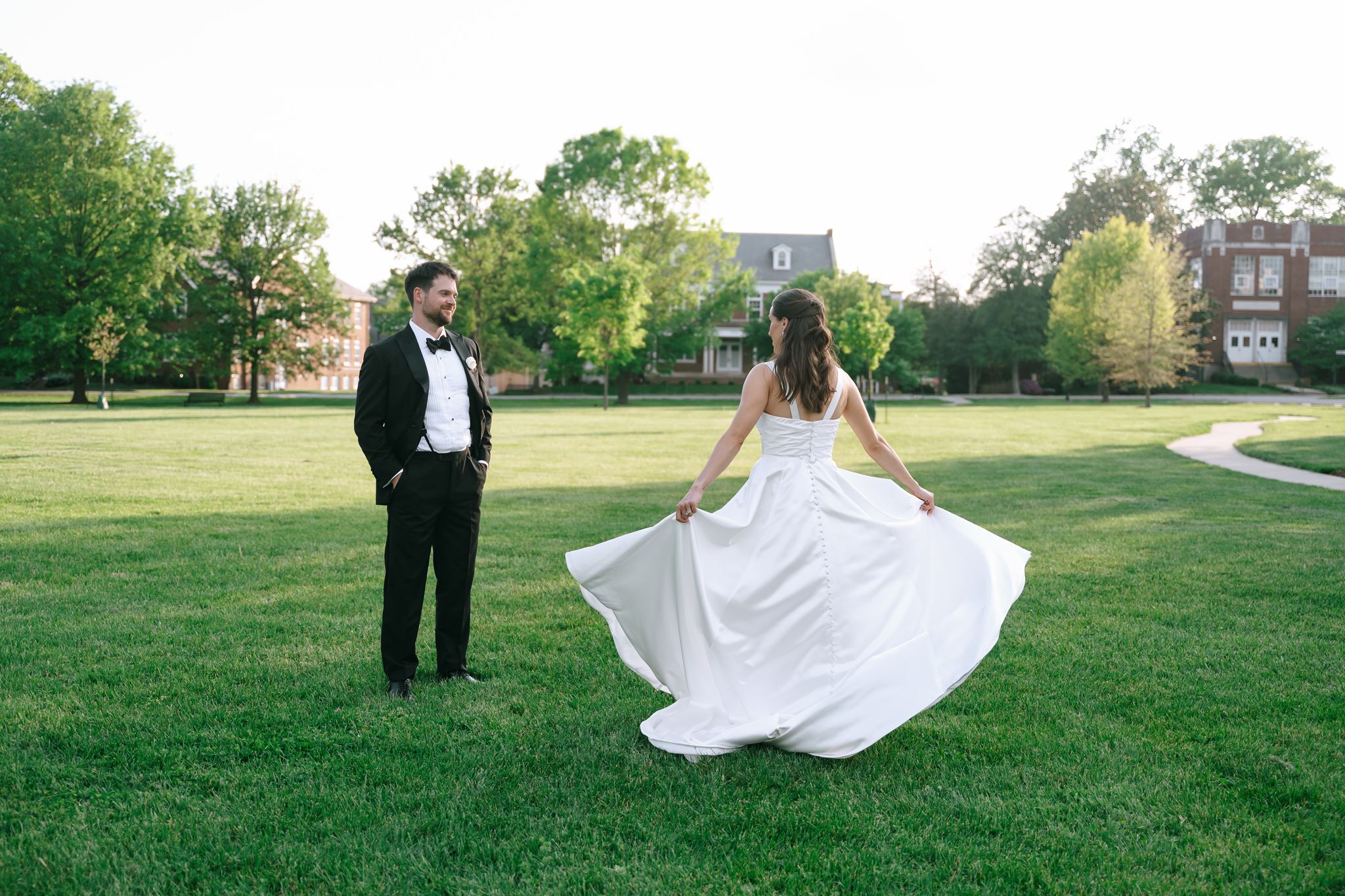 The Olmsted photos of the bride and groom sharing a quiet moment together on the lawn, with bride spinning her dress.