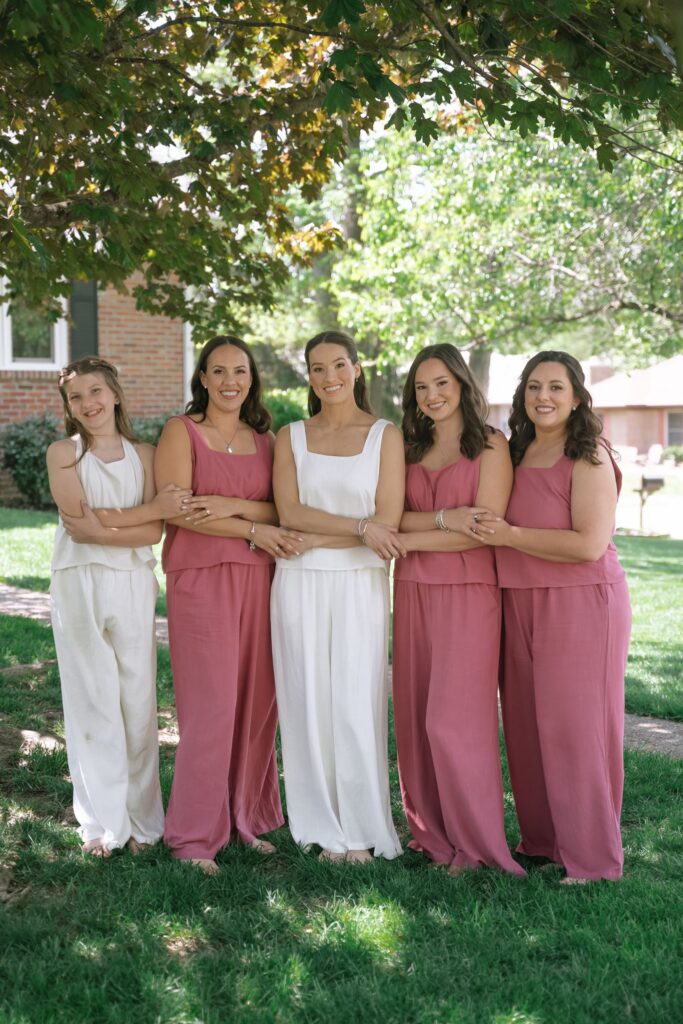 Bride with her bridesmaids and junior bridesmaid sharing a portrait outside The Olmsted Louisville.