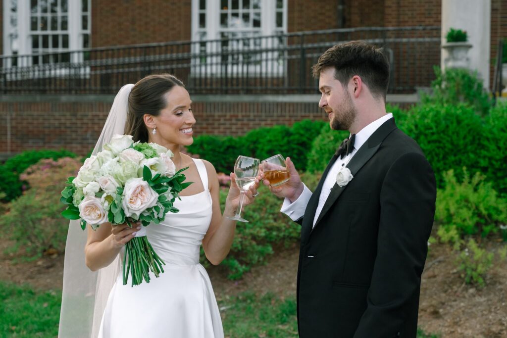 Bride and groom sharing a champagne toast outside The Olmsted Louisville after their wedding ceremony.
