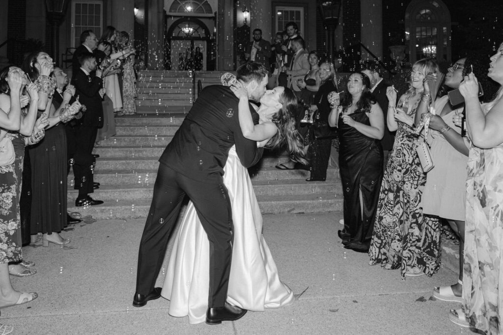 Bride and groom sharing a kiss during their bubble exit outside The Olmsted Louisville.