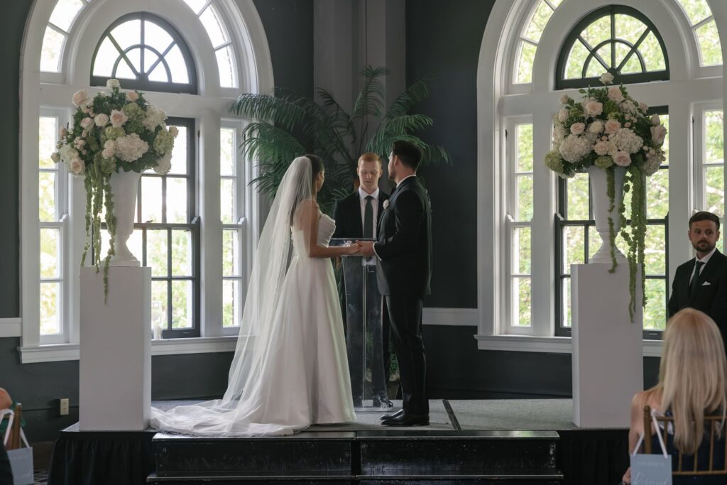 Bride and groom exchanging vows during their ceremony at The Olmsted wedding venue in Louisville.