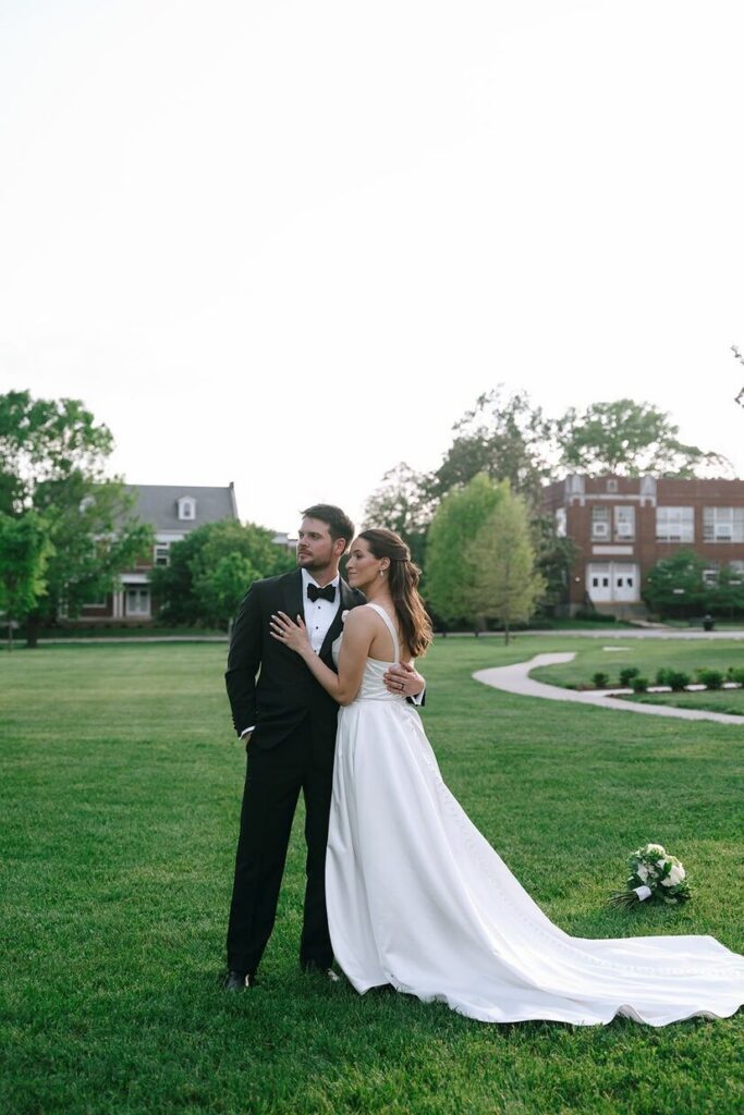 Couple looking off in the distance with historic homes in the background at Olmstead, a venue for outdoor weddings in Louisville, KY.