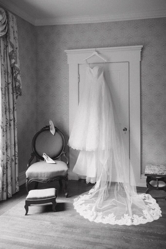 A wedding dress hanging on a door in Whitehall, an indoor and outdoor wedding venue in Louisville, KY.