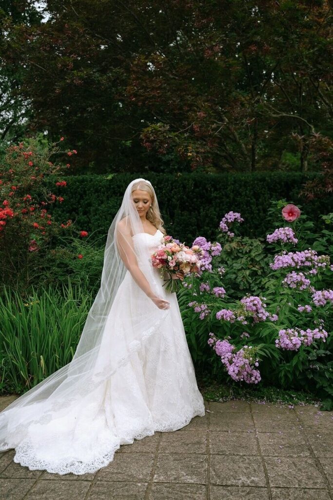 Bride looking down and holding her bouquet at the Whitehall wedding venue in Louisville.